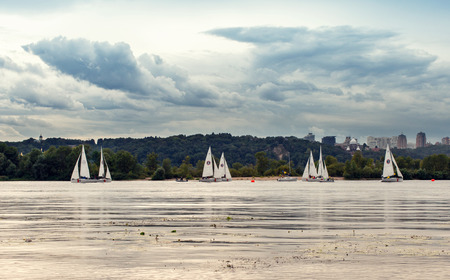 Competition with sailing sport on the river in the city.の写真素材