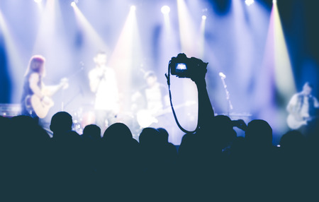 Crowd of young people resting on the rock concert. Crowd at concert and blurred stage lightsの写真素材
