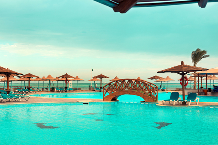 Swimming pool with sunbeds and umbrellas on the coast, Egyptの写真素材