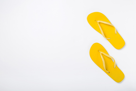 Yellow beach slippers on white background, top view.の写真素材