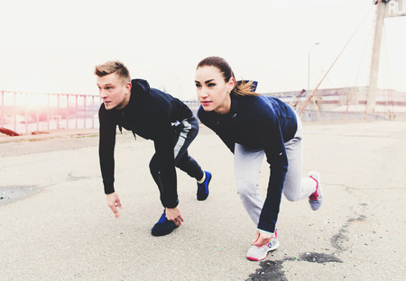 Two athletes are preparing to run on the street, copy spaceの写真素材
