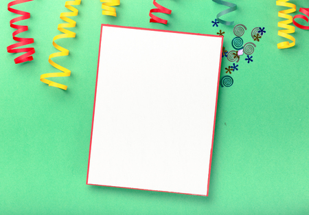 Blank card with colorful streamers and confetti on a bright background. Flat layの写真素材