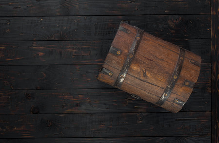 Old closed chest close up on dark wooden table with copy space, top viewの写真素材