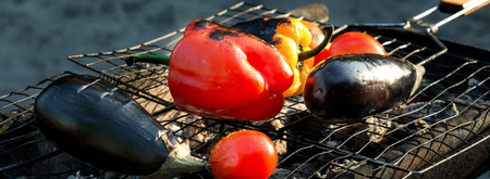 Close up grilled vegetables - Red and yellow pepper, eggplant and tomato on the grid grillの写真素材