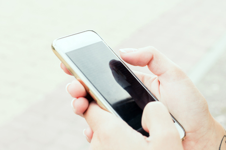 Close up of women's hands holding smartphone.の写真素材