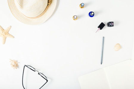 Frame with straw hat, starfish, glasses, pencil and nail polish. Flat lay, top view feminine summer...