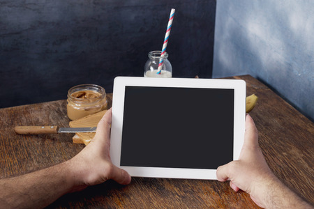 Digital tablet computer with isolated screen in male hands close upの写真素材