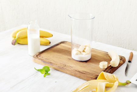Ingredients for banana milkshake in home kitchen. Healthy food conceptの写真素材
