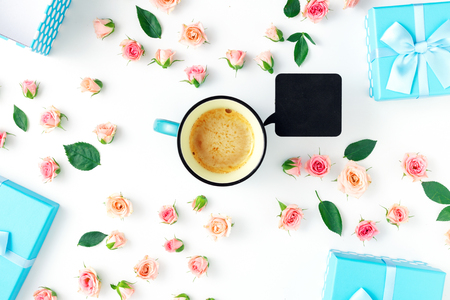 Coffee cup with blue gift boxes collection and pink roses on a white background  in flat lay style. Top viewの写真素材