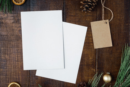Christmas background with two blank cards, price tag and decorations on dark wooden table, top viewの写真素材