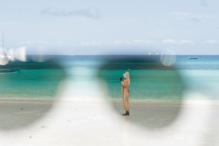 View of the ocean through the lens of sunglassesの写真素材