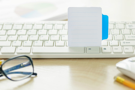 White paper stick in the keyboard close-upの写真素材