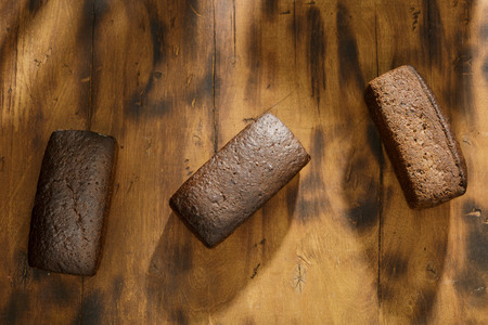 Top view three loaf of rye bread on a dark surface, top view