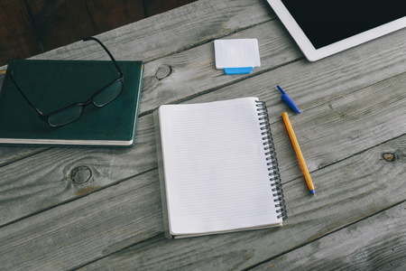 Home workspace concept. Notepad with pen on wooden home office deskの写真素材