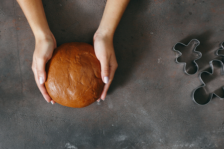 Women's hands holding fresh dough for cooking Christmas gingerbread cookies top viewの写真素材