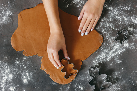 Female making festive Christmas gingerbread cookies top viewの写真素材