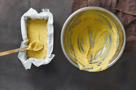 Raw dough for cooking corn bread on dark background, top viewの写真素材