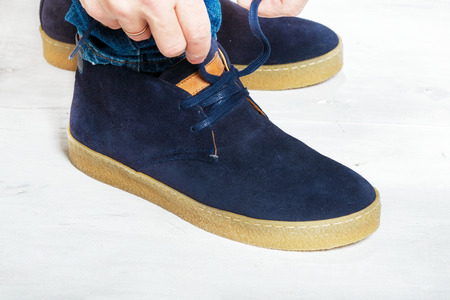 Mens suede sneakers close up on a white backgroundの写真素材