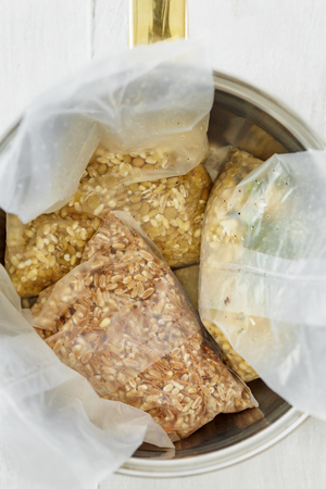 Set of various useful raw quick cook cereal in the casserole, top view. Barley couscous, pearl barley, bulgur wheat, green lentils. Healthy food concept. Different vegetarian cerealsの写真素材