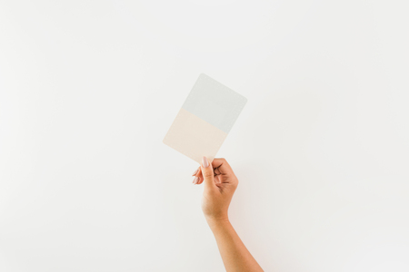 Woman hand holding card on white background. Flat lay, top viewの写真素材