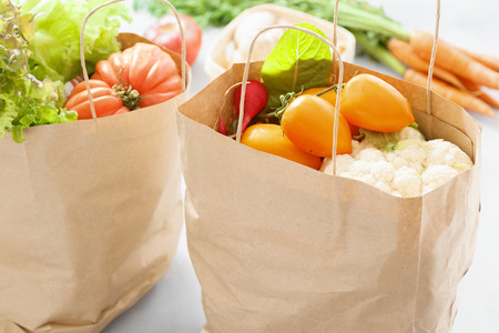 Two paper bag of healthy food on gray backgroundの写真素材