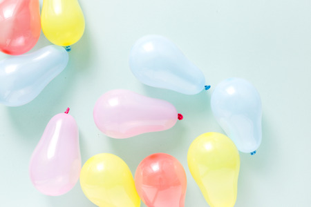 Set different colorful balloons on pastel blue background flat lay top view