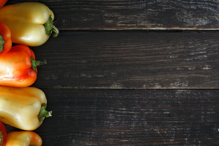 Top view set red and yellow homemade pepper on dark background with border
