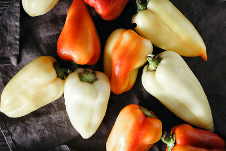 Red and yellow homemade pepper on a dark background, top viewの写真素材