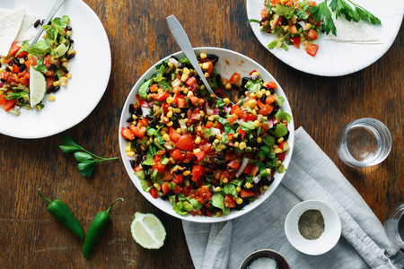 Top view Dinner table concept. Taco salad on wooden table