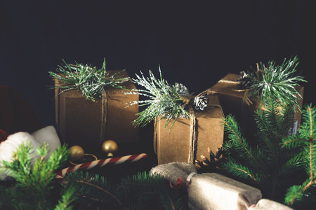 Christmas ornaments with gift boxes on wooden table.