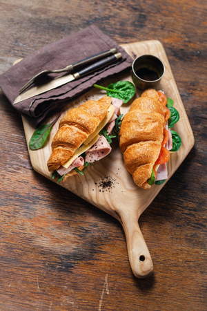 Croissants catering concept. Croissant sandwiches served on wooden boardの写真素材