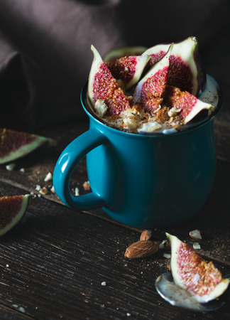 Vegetarian dessert from figs, almonds and vegan yogurt on dark wooden table. Rustic styleの写真素材