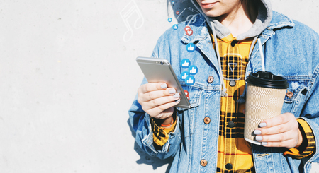 Young woman using smartphone to view streaming live videoの写真素材