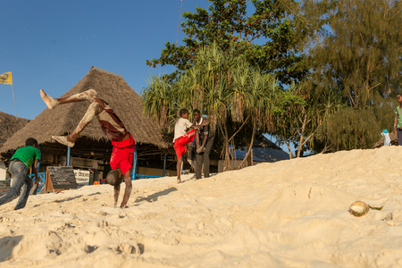 Zanzibar, Tanzania, Africa - February 3, 2017: Cheerful African teenagers having fun on the ocean beachのeditorial素材