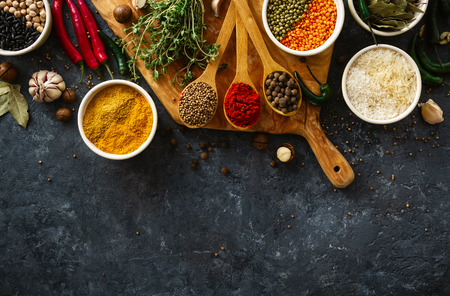 Spices, herbs, rice and various beans and seasonings for cooking on dark  with copy space top viewの写真素材
