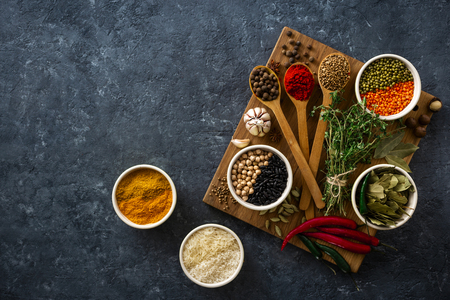 Spices, herbs, rice and various beans and seasonings for cooking on dark  with copy space top viewの写真素材