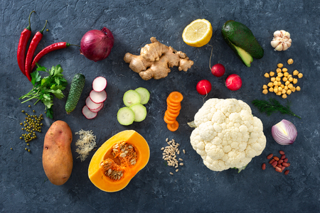 Raw ingredients cooking aloo gobi Indian food on dark stoneの写真素材