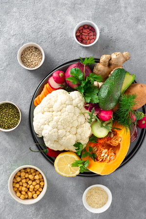 Raw ingredients cooking aloo gobi Indian food on concreteの写真素材