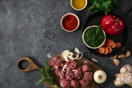 Ingredients for cooking meat with vegetables on a dark  top view. Preparation beef meatの写真素材