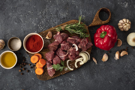 Ð¡ut of meat with vegetable on a dark  top viewの写真素材
