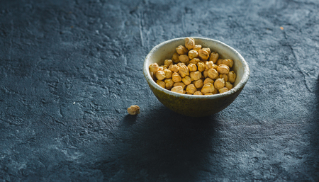 Bowl with chickpea close up on dark stone  with copy spaceの写真素材