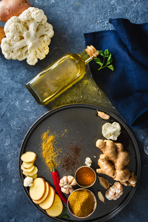 Raw Ingredients preparation aloo gobi Indian food on dark stone  top viewの写真素材