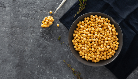 Cooking chickpeas in bowl on dark stone  top viewの写真素材