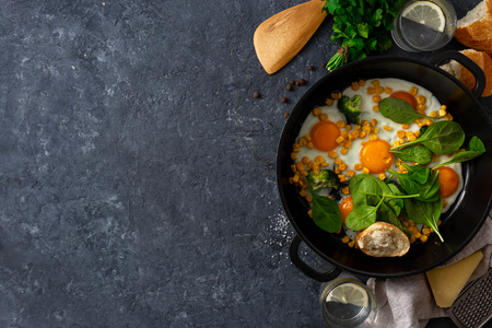 Healthy breakfast eggs top view on dark stone  with copy spaceの写真素材