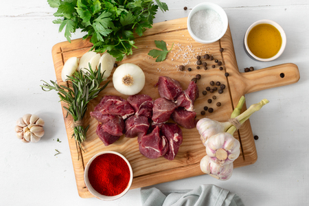 Raw meat and vegetables on white woodenの写真素材