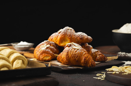 Breakfast croissant with chocolate on a dark stoneの写真素材