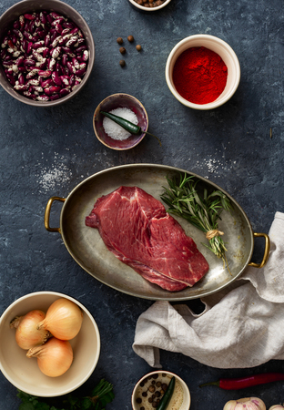 Raw steak with ingredients for cooking healthy food top viewの写真素材
