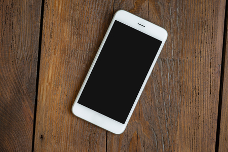 Phone screen empty on a wooden teble top viewの写真素材