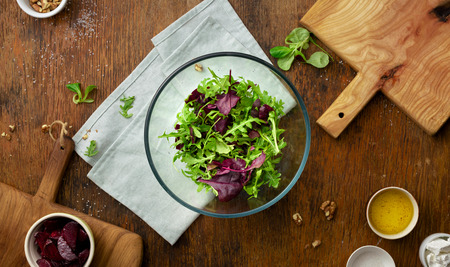 Raw ingredients for cooking fresh salad on wooden table top viewの写真素材