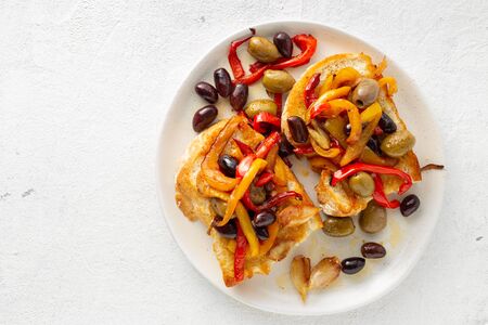 Sandwiches with grilled peppers, olives and garlic on a light background, top view. Flat layの写真素材